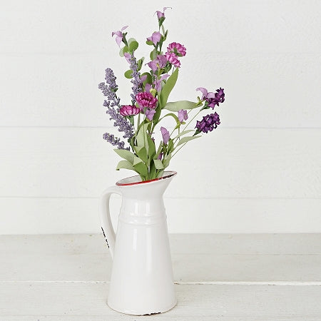 lavender and wild flowers in a white vase