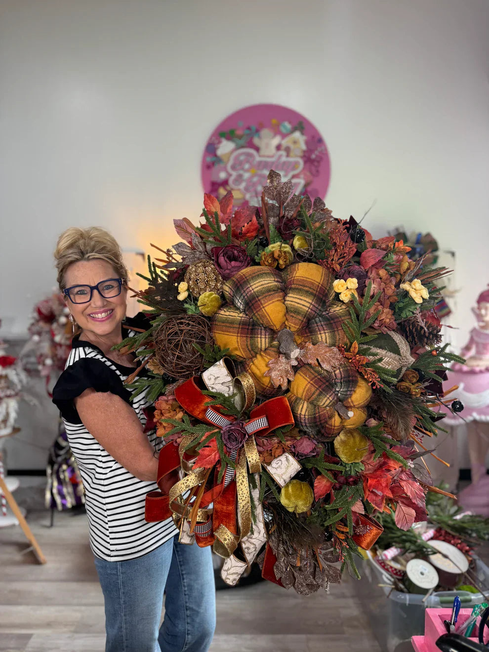 Jen shows off a plaid fall pumpkin wreath