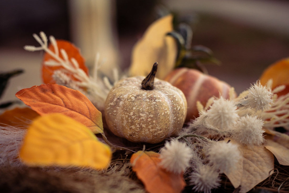 pumpkin and fall florals on a mantel