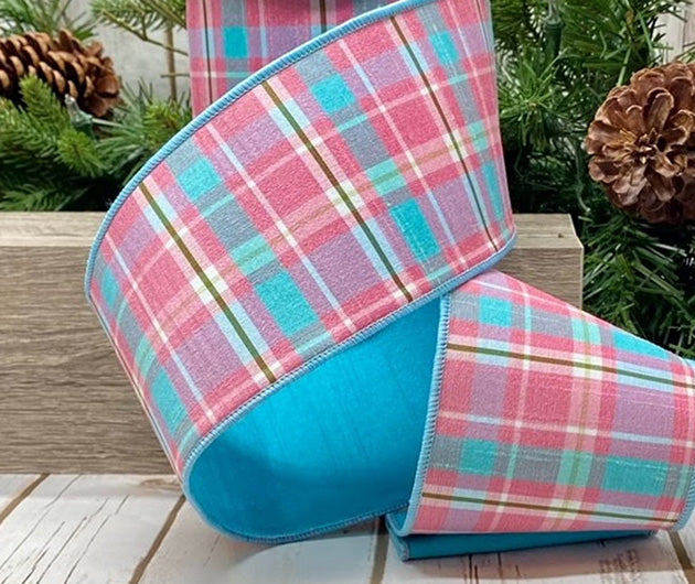 a roll of plaid pink and aqua ribbon